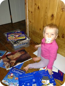 Christmas books Baby surrounded by Christmas books