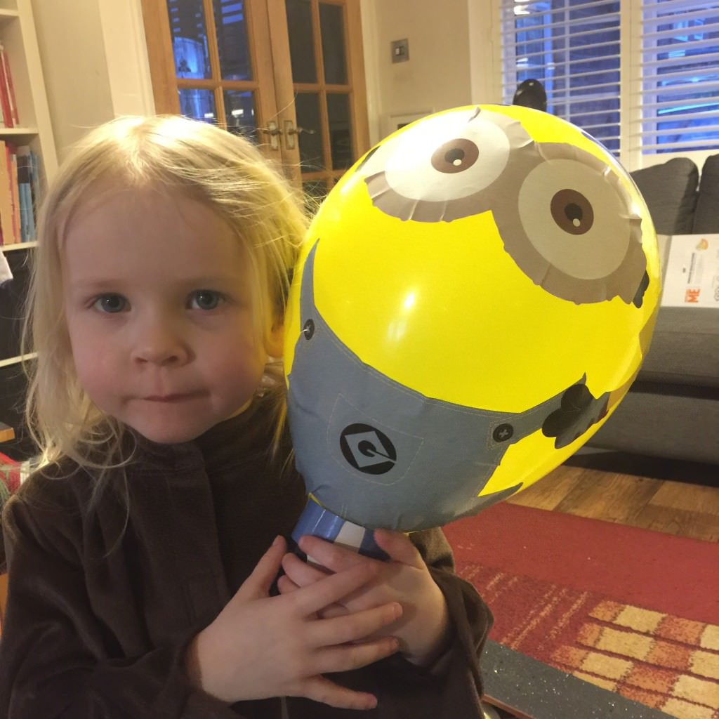 small child with Minion balloon