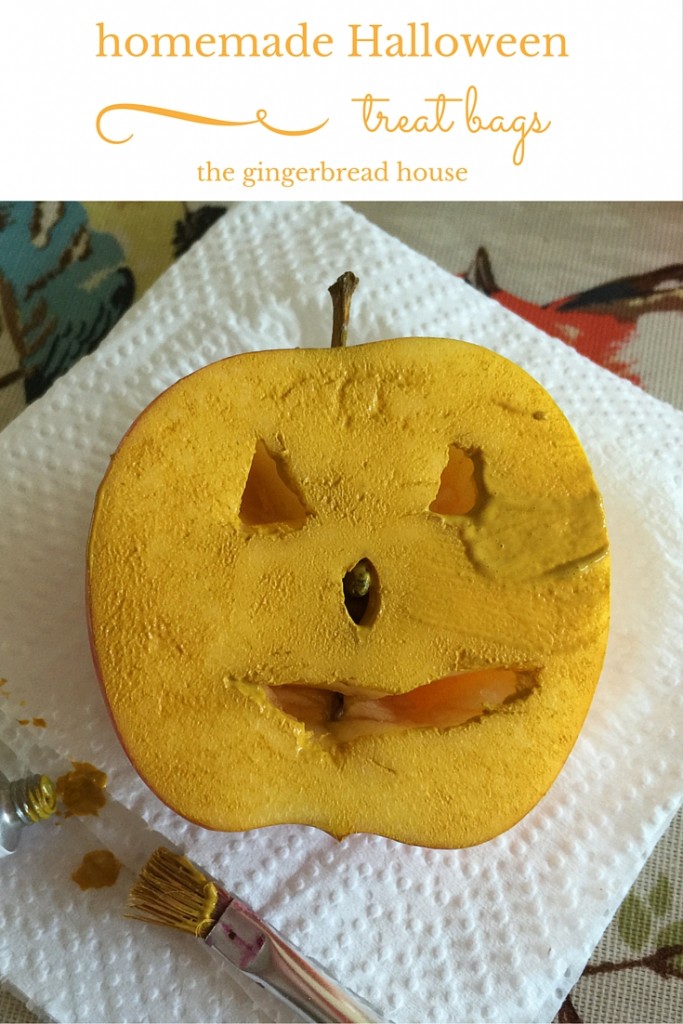 Homemade Halloween treat bag using apples to print pumpkins