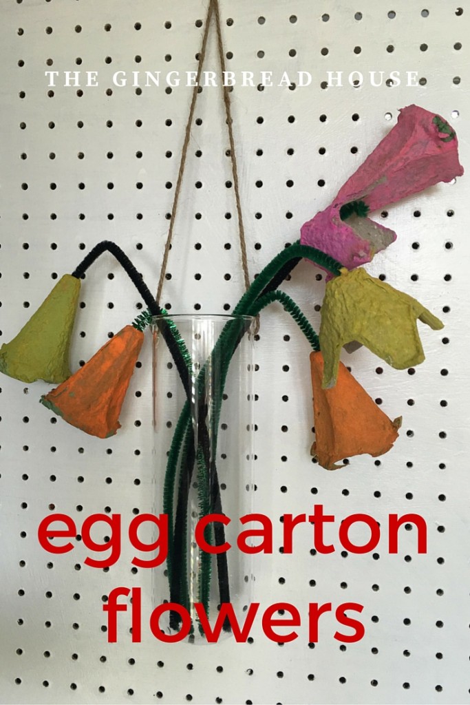 egg carton flowers in a hanging glass vase
