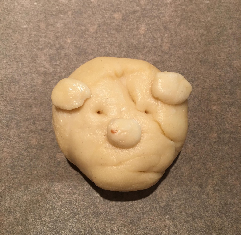 an uncooked bear bread roll