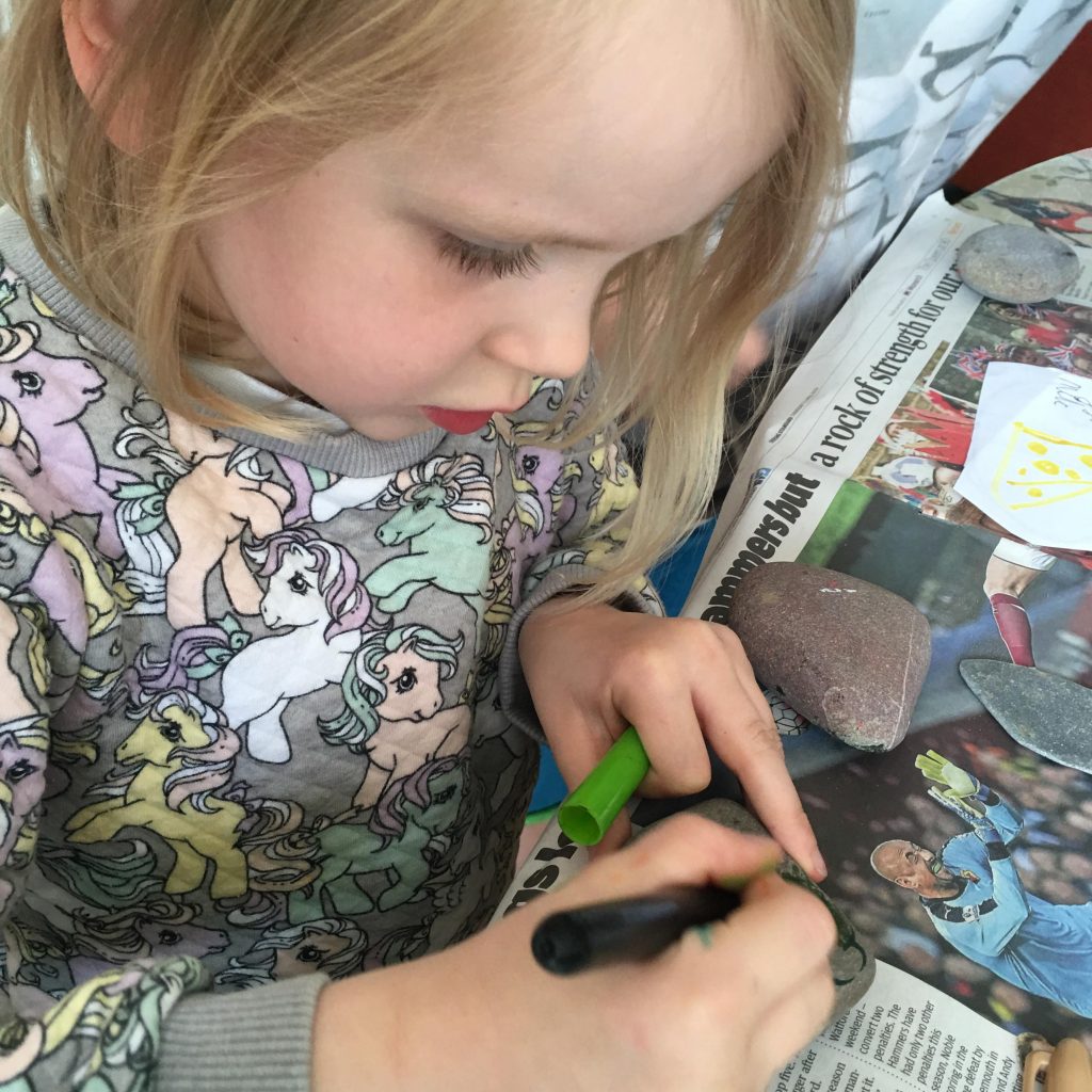 making simple mud kitchen food with stones